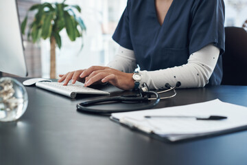 Poster - Its always good to have a notebook close by. Shot of an unrecognizable doctor using computer in an office.