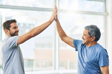 Aufkleber - Well done. Cropped shot of a young male physiotherapist and his senior patient high fiving after a great session.