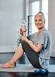 canvas print picture - Nothing better than a drink of water. Portrait of a cheerful mature woman practicing yoga while having a drink of water inside of a studio during the day.