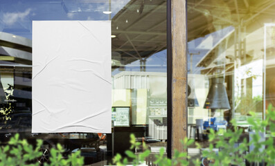 Wall Mural - Mockup white paper or white sticker poster displayed on the front of the restaurant, coffee shop, Promotion information for marketing announcements and details