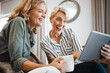 © N Felix/peopleimages.com - Thats an amazing video. Shot of two female friends drinking coffee while using a digital tablet.