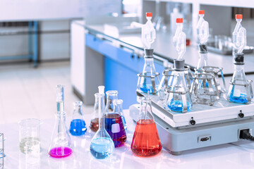 Wall Mural - glass flask in chemical science education laboratory with molecular structure in blue background