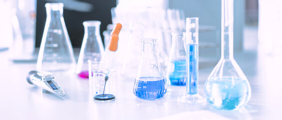 Wall Mural - glass flask in chemical science education laboratory with molecular structure in blue background