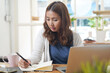 © Pormezz - Asian people study online course via internet. Young girl watching business lesson from laptop computer and note lecture to notebook at home.