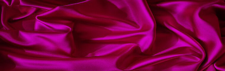 Wall Mural - Bright pink purple silk satin. Shiny silky surface of the fabric. Wavy folds. Elegant background with space for design. Web banner. Valentine, Christmas, holiday background.