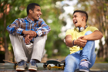 Poster - The skate park- their favorite city hangout. Shot of two young men having a laugh while out skateboarding.