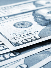 Wall Mural - american paper money. several one hundred dollar banknotes lie on textured surface. focus on the num