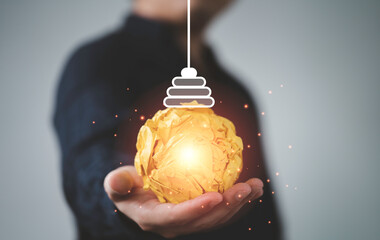 Poster - Businessman holding yellow scrap paper with illustration painting for virtual lightbulb. It is creative thinking idea and innovation concept.