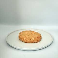 Sesame cookie on a plate on wihte isolated background.