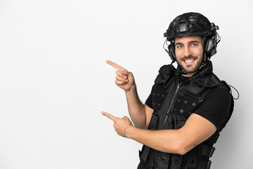 Wall Mural - Young caucasian swat isolated on white background pointing finger to the side and presenting a product