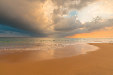 Wall Mural - Magnificent sandy ocean beach under gorgeous sunset sky with clouds. Beautiful seascape.