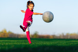 Fototapeta Sport - Little girl in a soccer training