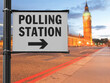 polling station sign over blurred parliament background