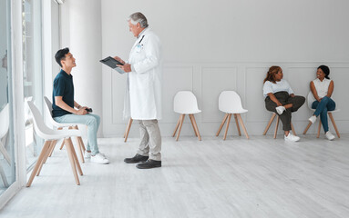 Aufkleber - A visit to the doctor doesnt have to be a dreadful thing. Shot of a mature doctor meeting with a young man in the waiting room of a clinic.