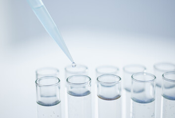 Aufkleber - Practising precision in the lab. Closeup shot of a dropper being used to fill test tubes in a lab.