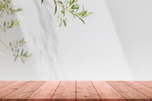 Empty Wood Table Top And Blurred White Wall In Garden Background With Green Leaves - Can Used For Display Or Montage Your Products.