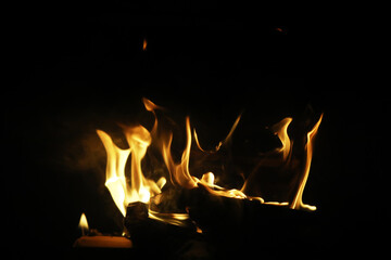 Wall Mural - The flames of burning wood in the fireplace of a country house. Coals and sparks.