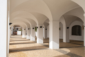 Sticker - whitewashed portico with many arches and a patterned stonework floor