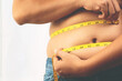 fat man check out body overweight abdomen his belly with in hand measuring tape f