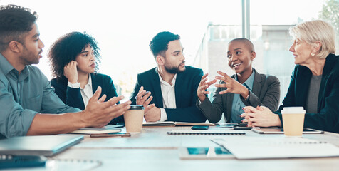 Wall Mural - I have a different approach to the problem. Shot of a diverse group of businesspeople sitting in the office together and having a meeting.