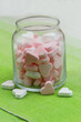 Pink and white sugar hearts in transparent glass bottle
