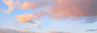 Clear blue sky. glowing pink, golden cirrus and cumulus clouds after storm, soft sunlight. Sunset cloudscape. Meteorology, midnight sun, heaven, peace, graphic resources, picturesque panoramic scenery