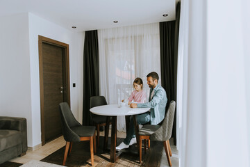 Wall Mural - Father and daughter drinking tea together at the room