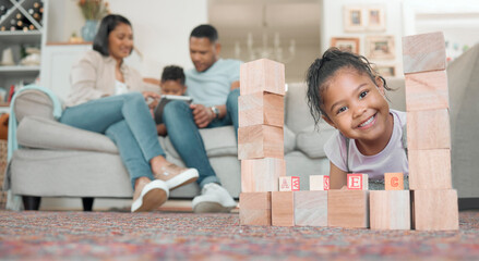 Wall Mural - I rather play with blocks than with technology. Shot of an adorable little girl playing with building blocks in the living room at home.