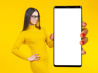 Poster - Businesswoman phone. Big phone. Woman on bright yellow background. Place of your online ad. Smartphone blank screen. Cell phone white display. Space for business application. Cellphone mock up