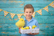 © Jacek - A young boy and decorations for Easter. Studio background.