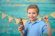 © Jacek - A young boy and decorations for Easter. Studio background.