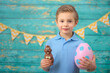 © Jacek - A young boy and decorations for Easter. Studio background.