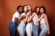 © iordani - young pretty asian, caucasian, african woman posing cheerful together on brown background, lifestyle diverse nationality people concept