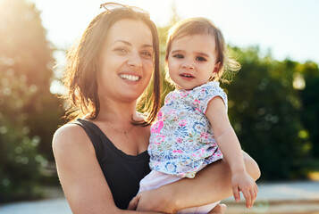 mommys best friend. shot of a young mother and her little girl outdoors.