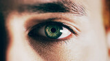 Fototapeta  - You see nature in his eyes. Closeup shot of man opening his eyes against a dark background.
