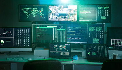 Control room monitoring surveillance video camera control city - Empty space dark room office full of screen device from secret service public safety computer station center. No people indoors. 