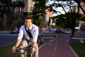 Wall Mural - No gym membership needed. Shot of a businessman commuting to work with his bicycle.
