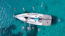 Top View Of Young Friends Jumping From Sailboat. Yachting. Sail Boat Party Day. Summer Luxury Boat Trip