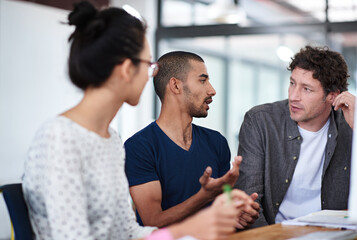 Aufkleber - Make creativity a job. Shot of a group of young coworkers talking at a deask.