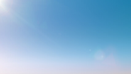 light blue sky background with sun glare. clean gradient light blue background. beautiful light back