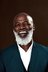 Poster - Staying positive is whatll help you win. Studio shot of a mature businessman posing against a brown background.