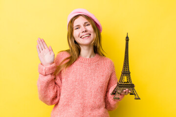 red head pretty woman smiling happily, waving hand, welcoming and greeting you. french concept