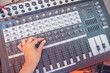 © aFotostock - Production sound engineer hands working on recording studio mixing voice control. Expert adjusting volume equalizer voice, mixing console DJ sound engineering. Producer remix tune music sound record