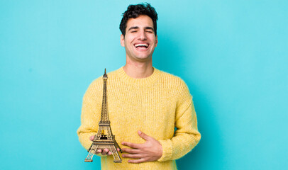 handsome hispanic man laughing out loud at some hilarious joke. france concept