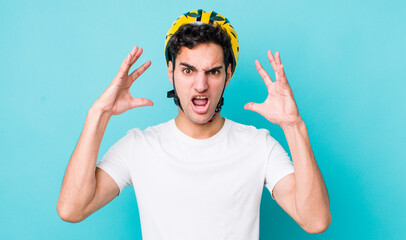 Poster - handsome hispanic man screaming with hands up in the air. bike concept