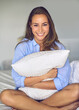 © Thurstan Hinrichsen/peopleimages.com - Begin each day with a beautiful heart. Portrait of an attractive young woman hugging a pillow in her bedroom.
