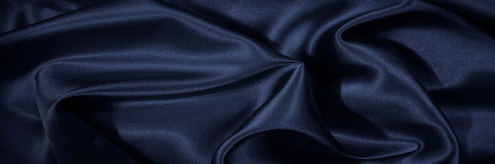 Wall Mural - Black blue silk, satin. Shiny fabric surface. Beautiful wavy folds. Dark elegant background with space for design. Web banner.