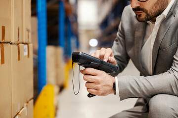 Wall Mural - Close up of a supervisor using scanner in warehouse.