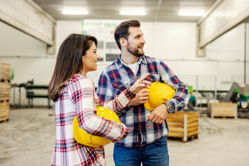 Wall Mural - Two factory dispatchers on workplace pointing at something in storage.