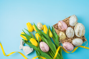 Wall Mural - Easter holiday composition with Easter golden eggs and yellow  tulip flowers. Top view, flat lay with copy space